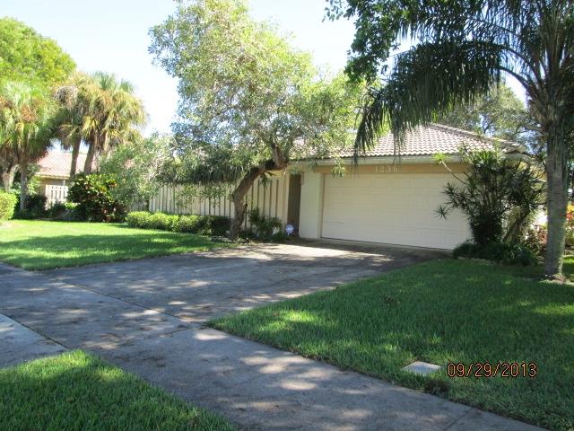 1236 Northwest 16th Street Boca Raton, FL 33486 - Photo 2 of 17 a view of a backyard with a garden