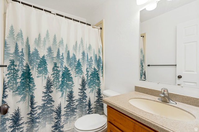 1585 South 910 West Payson, UT 84651 - Photo 22 of 32 Bathroom vanity featuring a light-toned countertop with an integrated sink and a wood-finish cabinet base