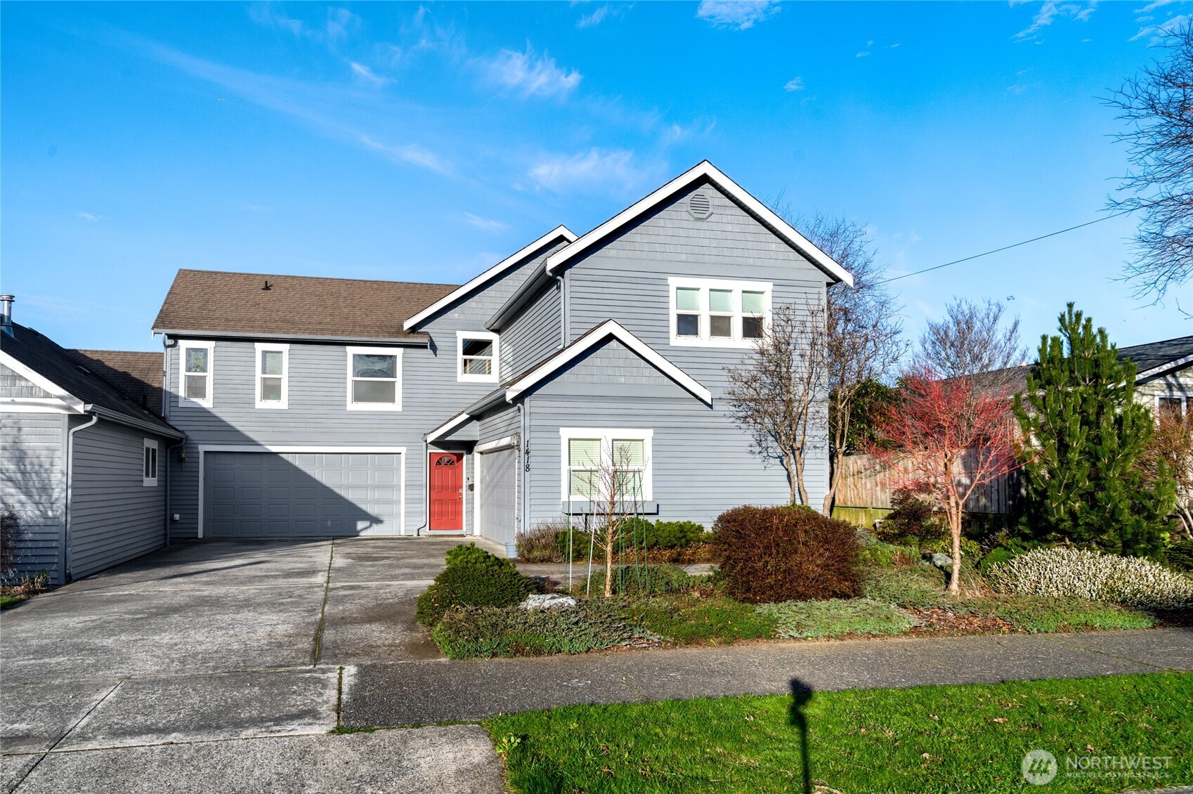 a front view of a house with a yard and garage