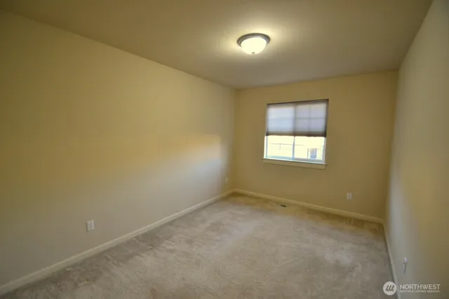 an empty room with a empty space and windows