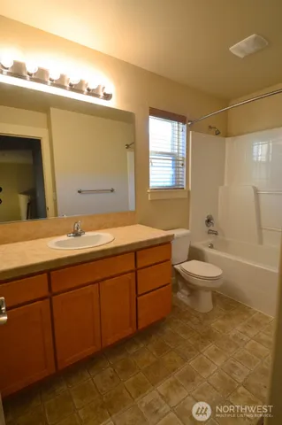 a bathroom with a double vanity sink toilet and shower