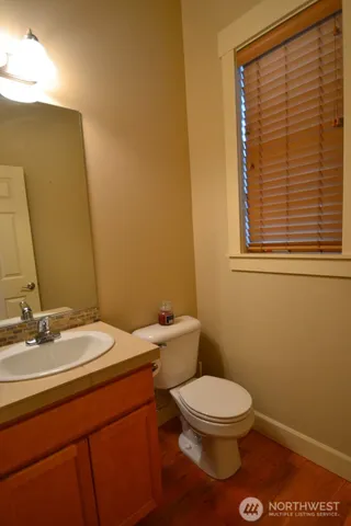 a bathroom with a toilet a sink and a mirror