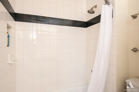 a bathroom with a shower and a mirror