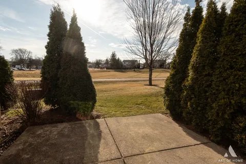 a view of a yard with wooden fence