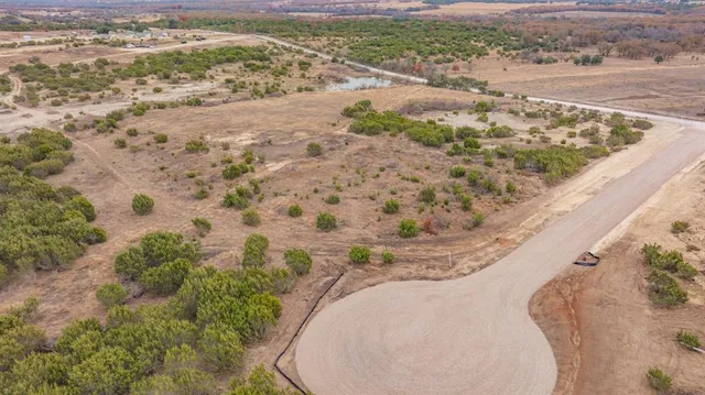 a view of a dry backyard of the house