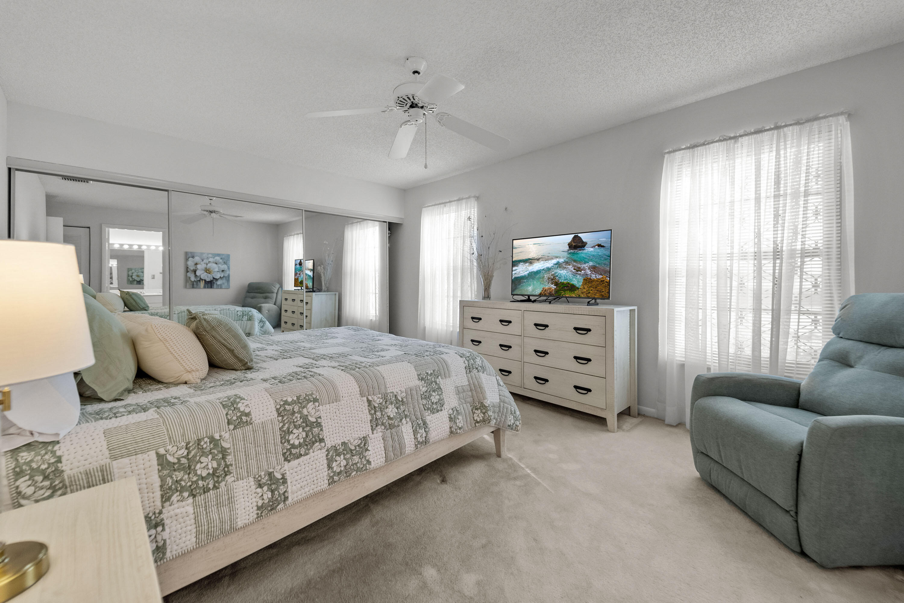 5080 Nesting Way, Unit A Delray Beach, FL 33484 - Photo 13 of 37 a bedroom with a bed and a couch