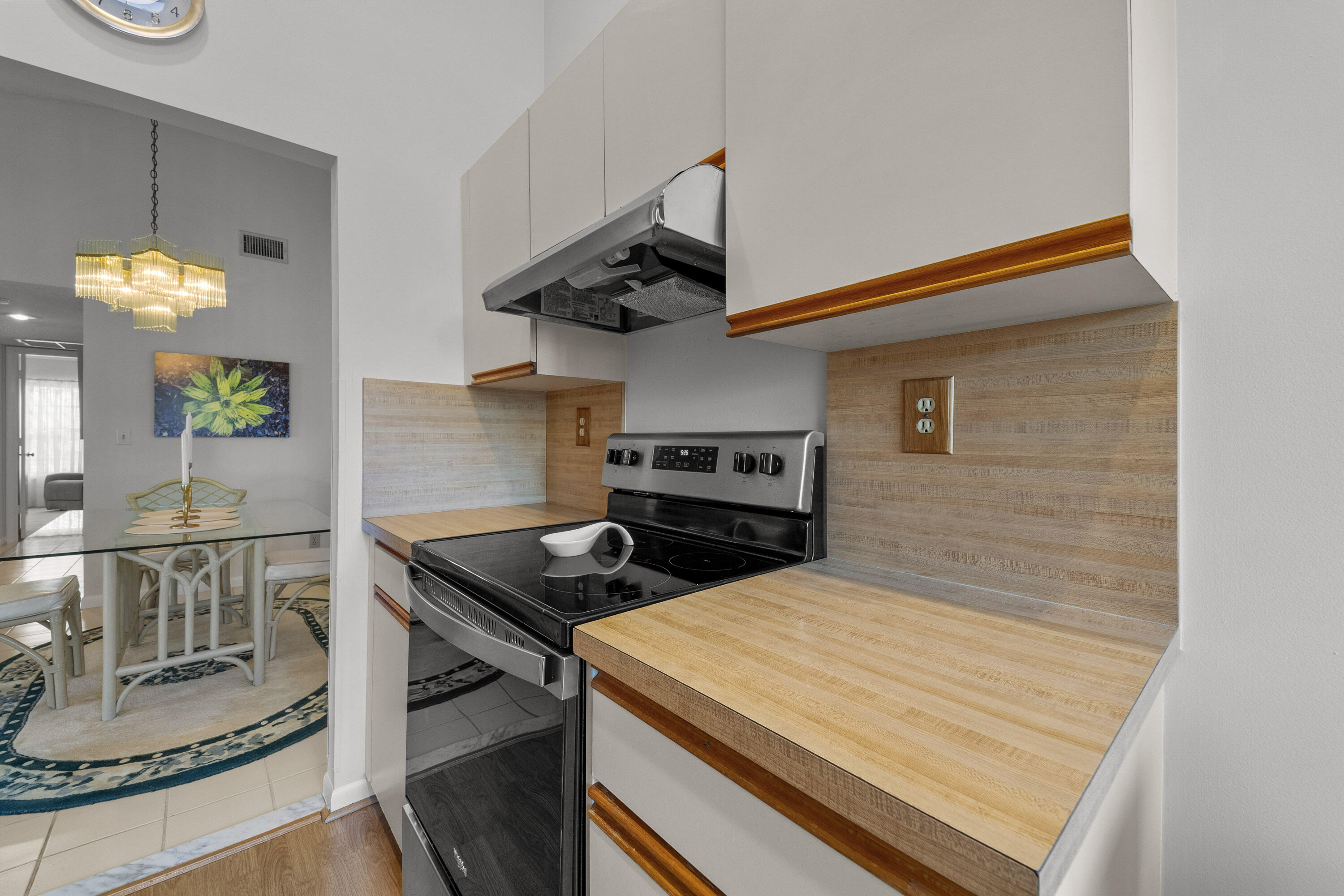 5080 Nesting Way, Unit A Delray Beach, FL 33484 - Photo 23 of 37 a kitchen that has a stove and a table in it