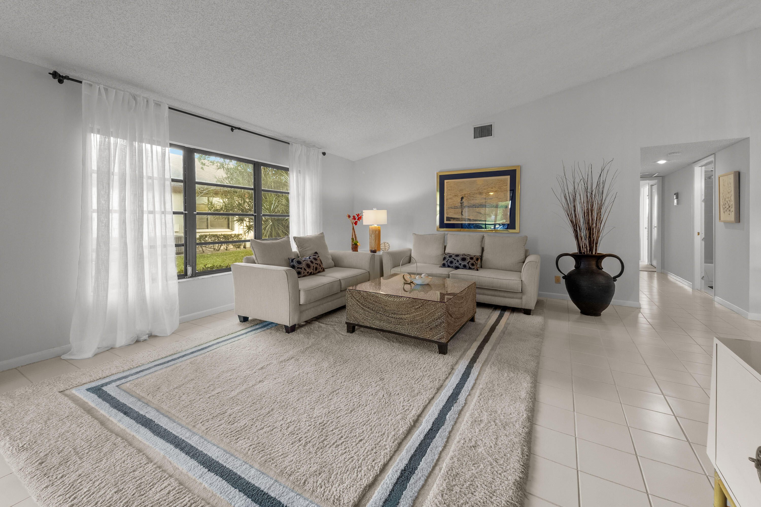 5080 Nesting Way, Unit A Delray Beach, FL 33484 - Photo 4 of 37 a living room with furniture rug and window