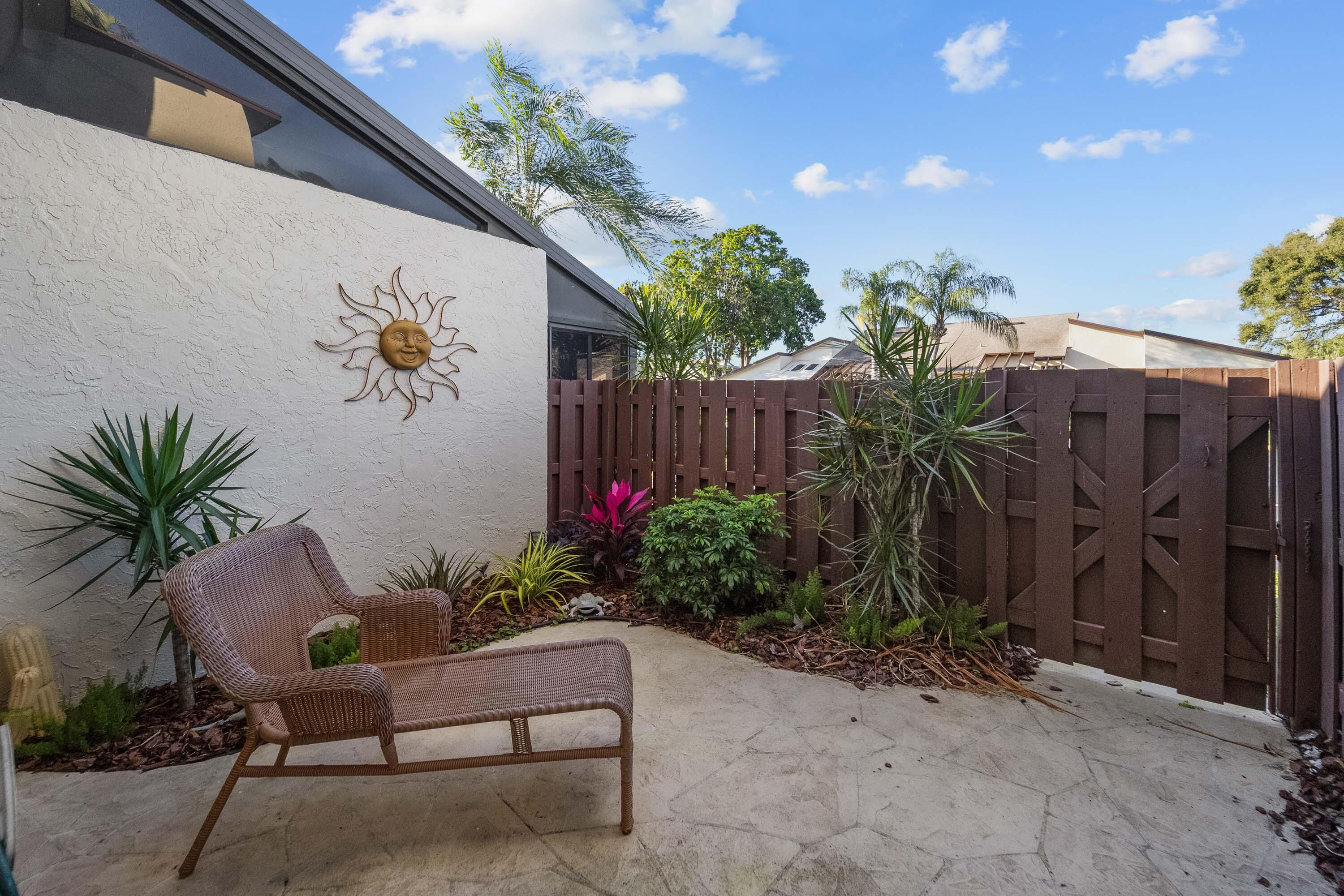 5080 Nesting Way, Unit A Delray Beach, FL 33484 - Photo 6 of 37 a view of a backyard with a garden