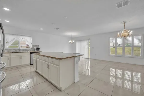 a kitchen with granite countertop a sink and cabinets