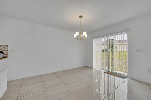 a view of a livingroom with a chandelier fan