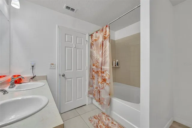 a bathroom with a tub and shower