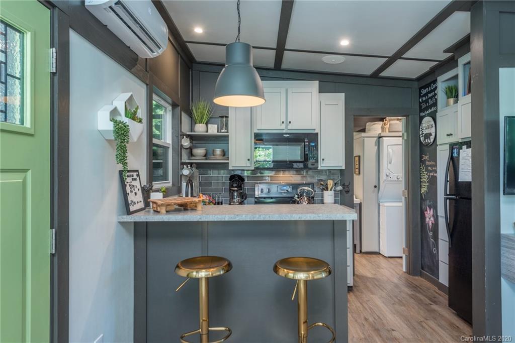 787 Ridge Road Marion, NC 28752 - Photo 18 of 47 a kitchen with stainless steel appliances granite countertop a refrigerator a stove and a wooden floors