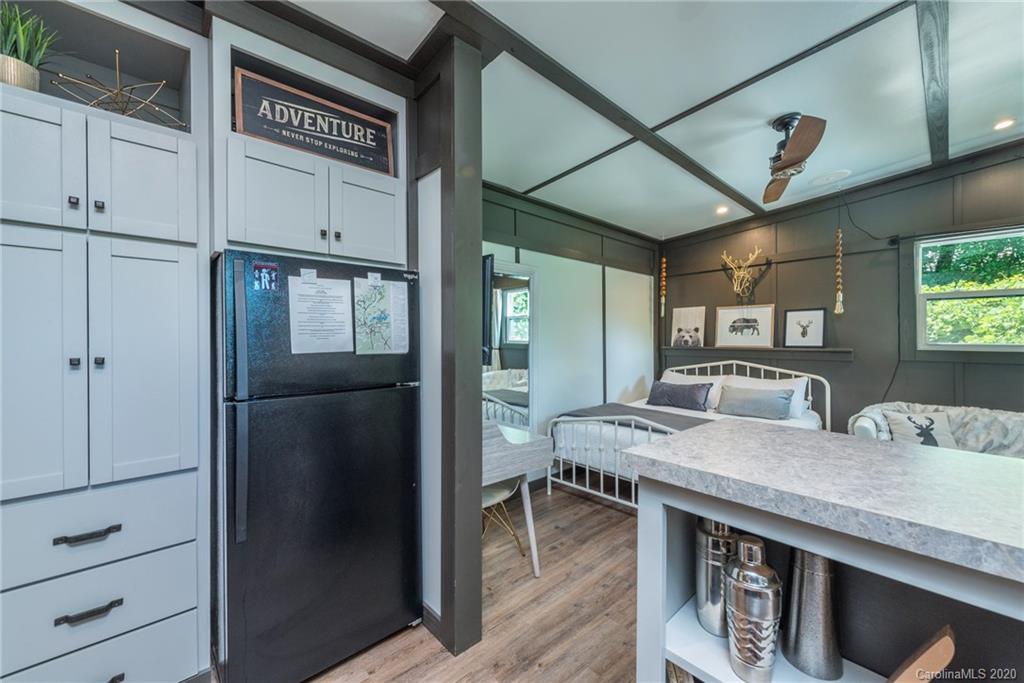 787 Ridge Road Marion, NC 28752 - Photo 22 of 47 a kitchen with stainless steel appliances granite countertop a refrigerator a sink and white cabinets