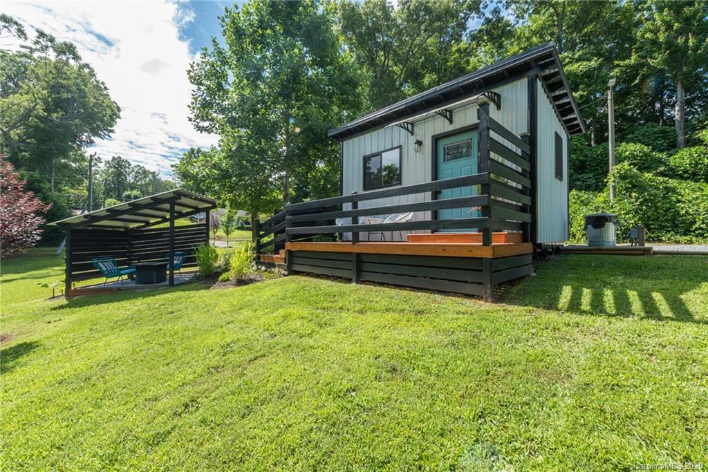 787 Ridge Road Marion, NC 28752 - Photo 29 of 47 a backyard of a house with barbeque oven and trees