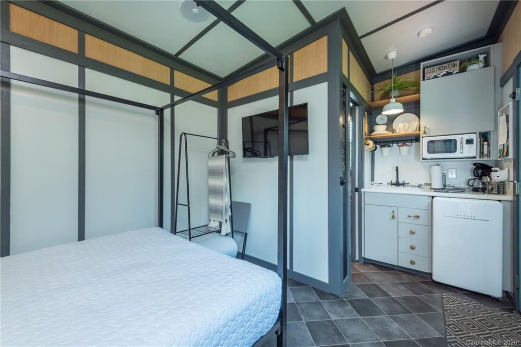 787 Ridge Road Marion, NC 28752 - Photo 38 of 47 a spacious bathroom with a granite countertop sink a mirror and a shower