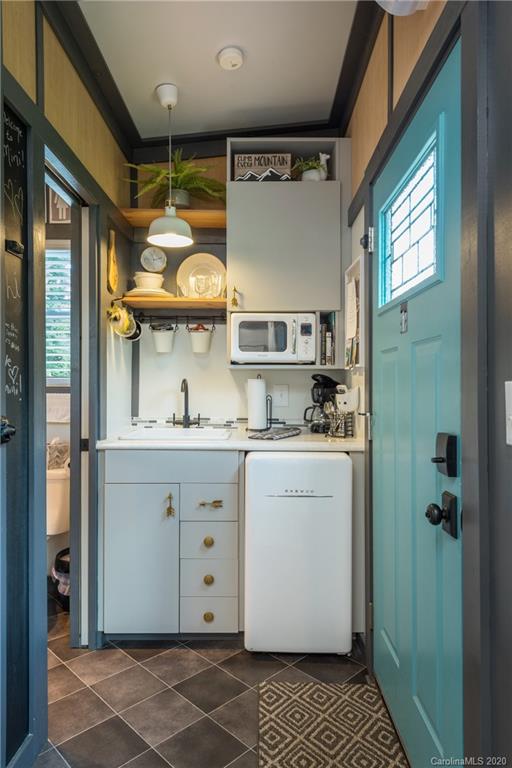 787 Ridge Road Marion, NC 28752 - Photo 40 of 47 a room with a white cabinets and window