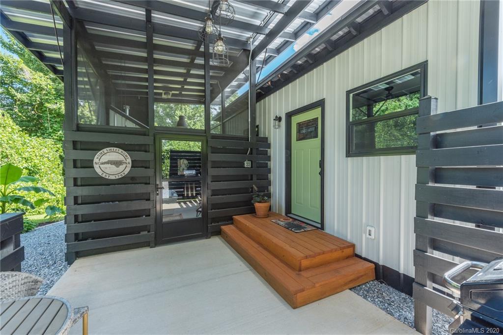 787 Ridge Road Marion, NC 28752 - Photo 10 of 47 a backyard of a house with barbeque oven fence and windows