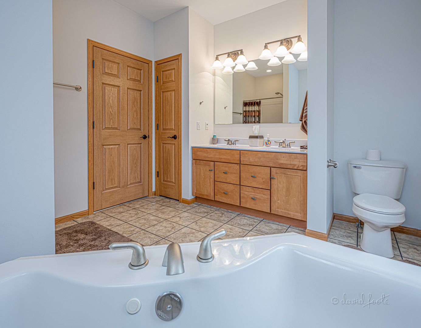 4 Saddleback Road Galena, IL 61036 - Photo 17 of 30 a spacious bathroom with a sink a toilet a mirror and shower