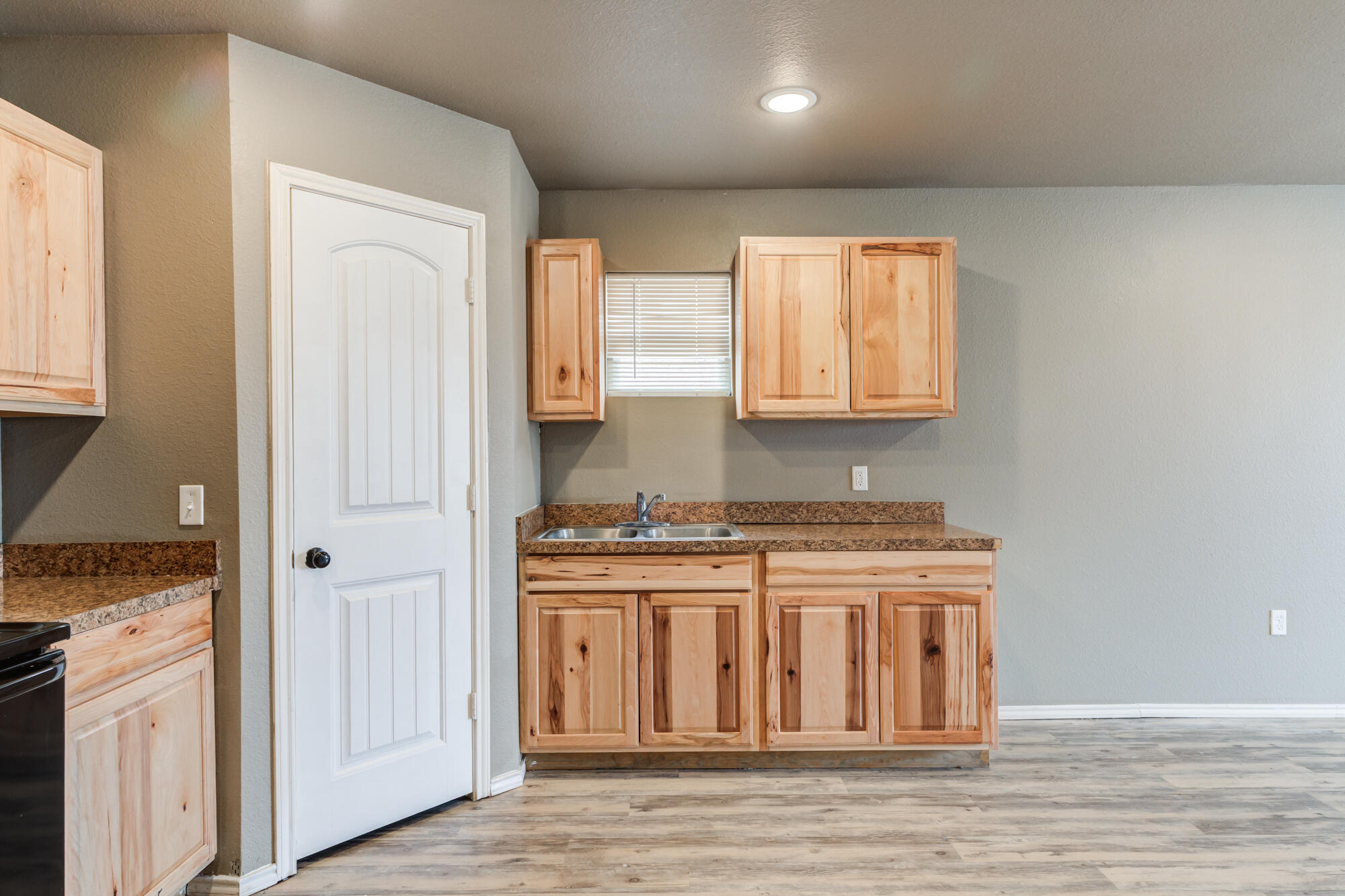 2832 East 7th Street Lubbock, TX 79403 - Photo 11 of 25 a kitchen with stainless steel appliances granite countertop a stove and a refrigerator