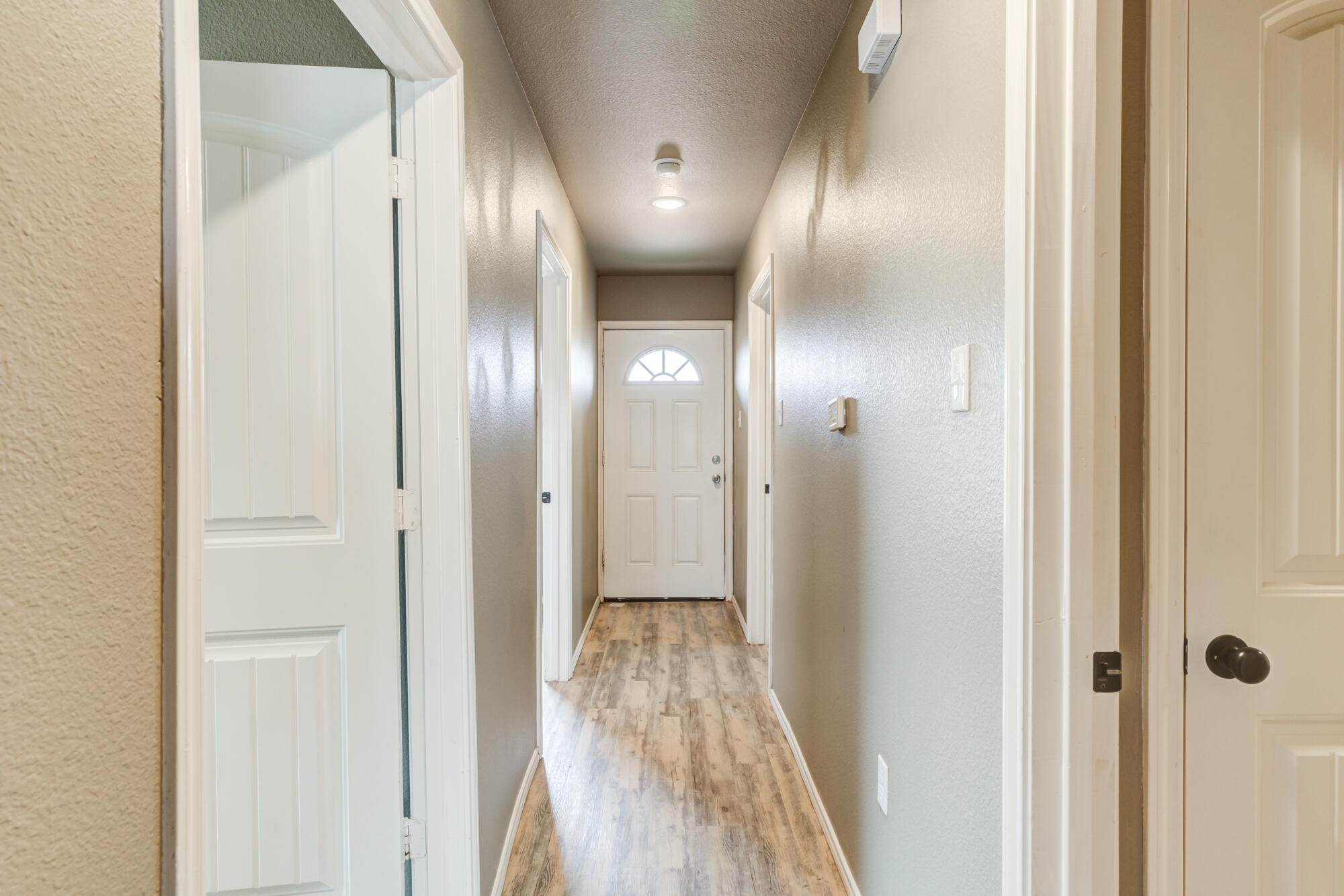 2832 East 7th Street Lubbock, TX 79403 - Photo 16 of 25 a view of a hallway with wooden floor