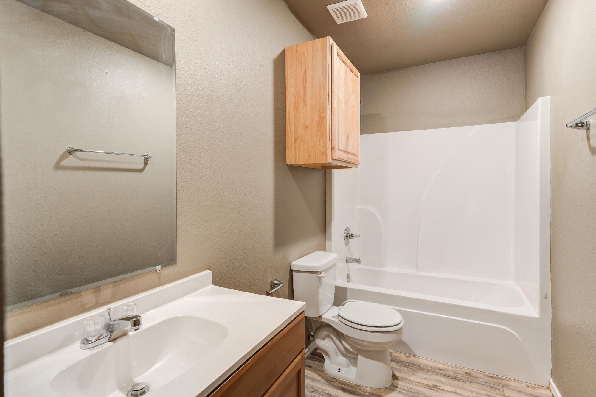 2832 East 7th Street Lubbock, TX 79403 - Photo 17 of 25 a bathroom with a granite countertop toilet sink and mirror