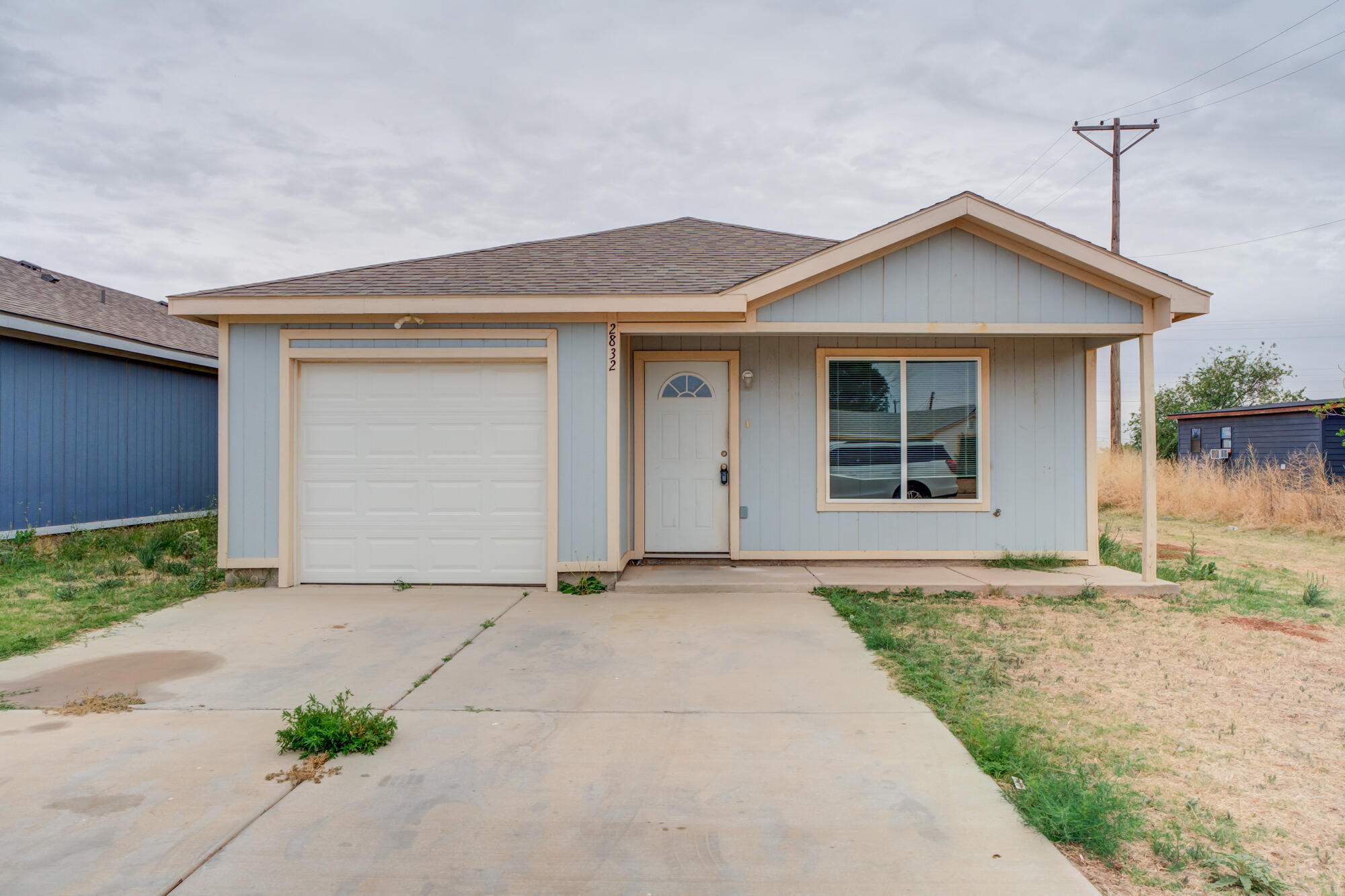 2832 East 7th Street Lubbock, TX 79403 - Photo 2 of 25 a front view of a house with a yard and garage