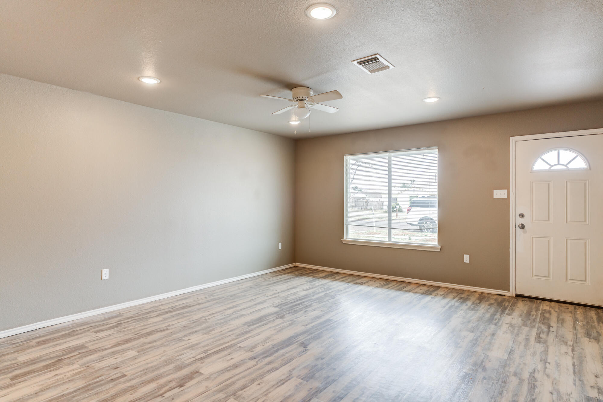 2832 East 7th Street Lubbock, TX 79403 - Photo 3 of 25 an empty room with wooden floor and windows