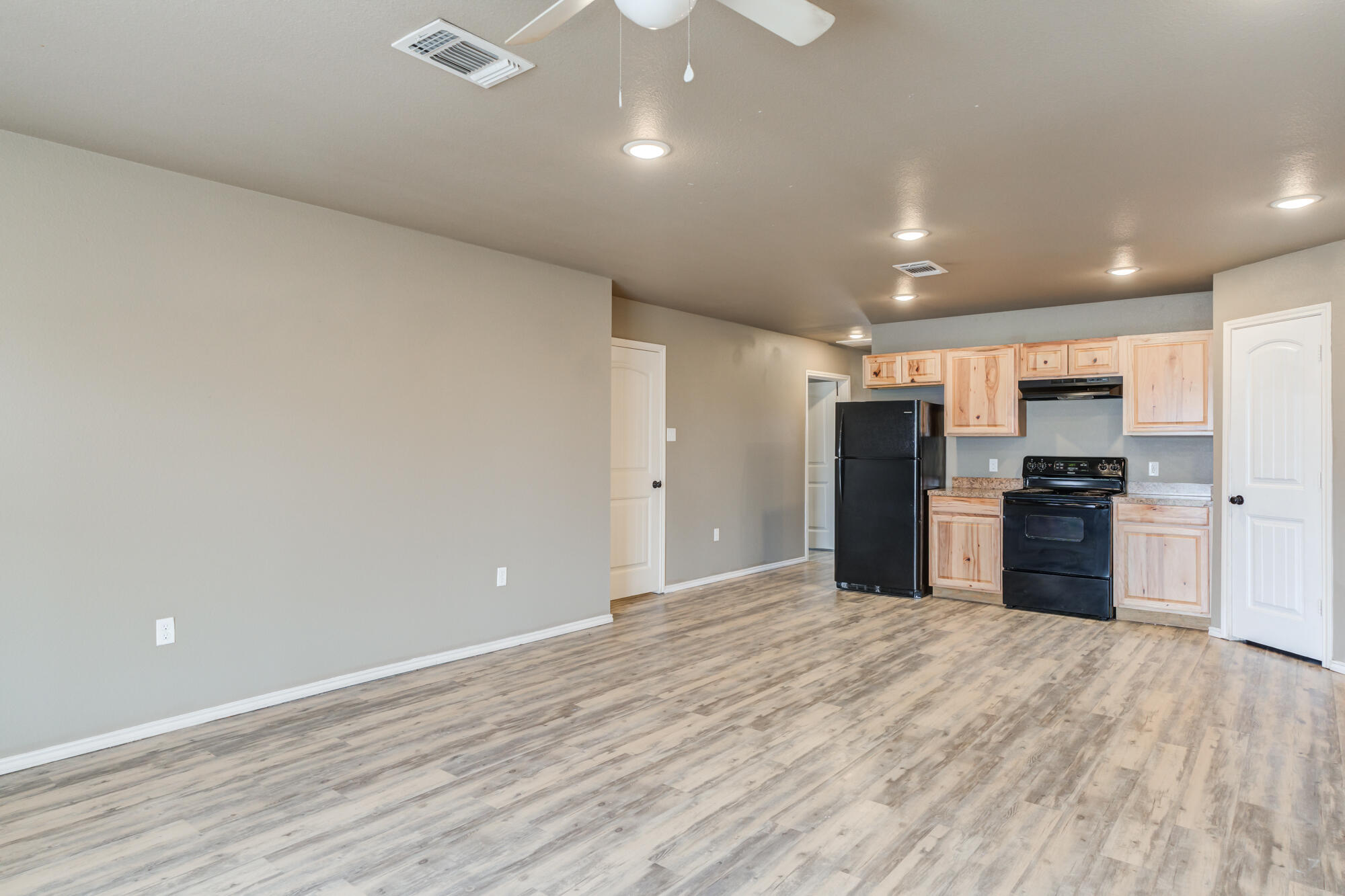 2832 East 7th Street Lubbock, TX 79403 - Photo 6 of 25 a view of kitchen with refrigerator and wooden floor