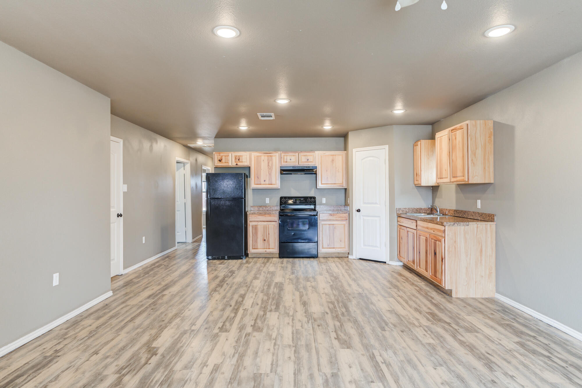 2832 East 7th Street Lubbock, TX 79403 - Photo 7 of 25 a large kitchen with kitchen island a sink stainless steel appliances and cabinets