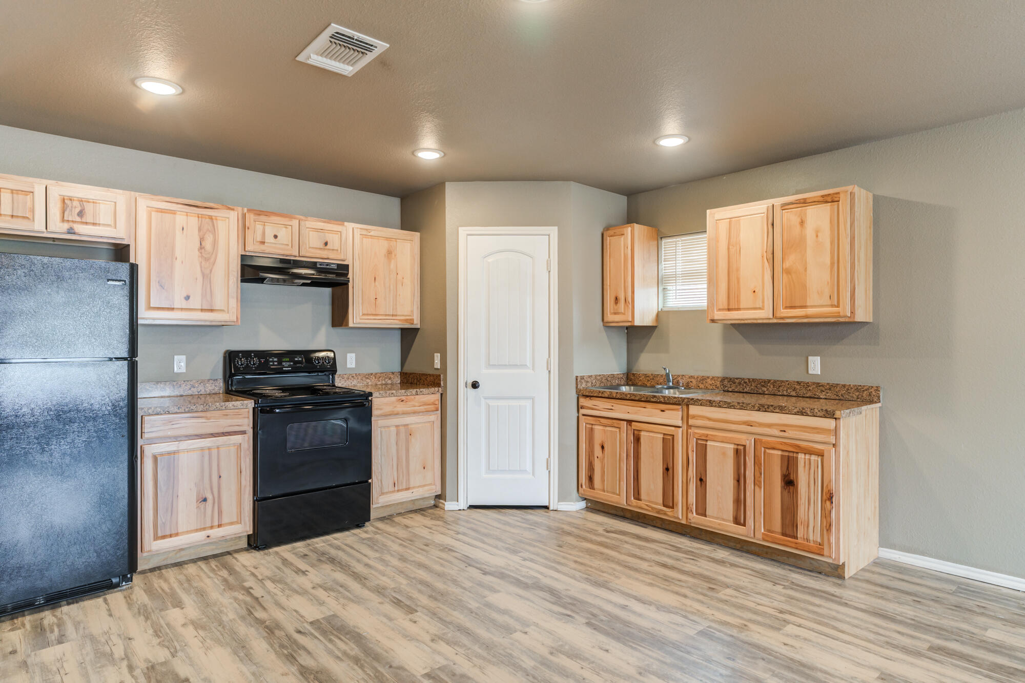2832 East 7th Street Lubbock, TX 79403 - Photo 9 of 25 a kitchen with stainless steel appliances granite countertop a stove a refrigerator and a sink