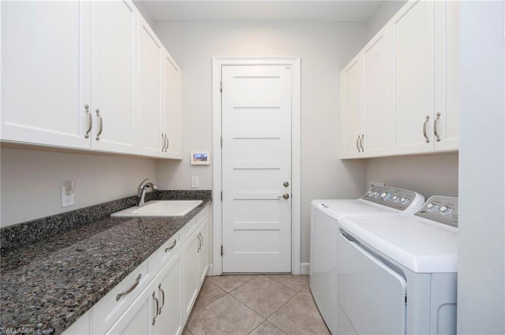 6466 Warwick Avenue Naples, FL 34113 - Photo 19 of 43 a kitchen with a sink and cabinets