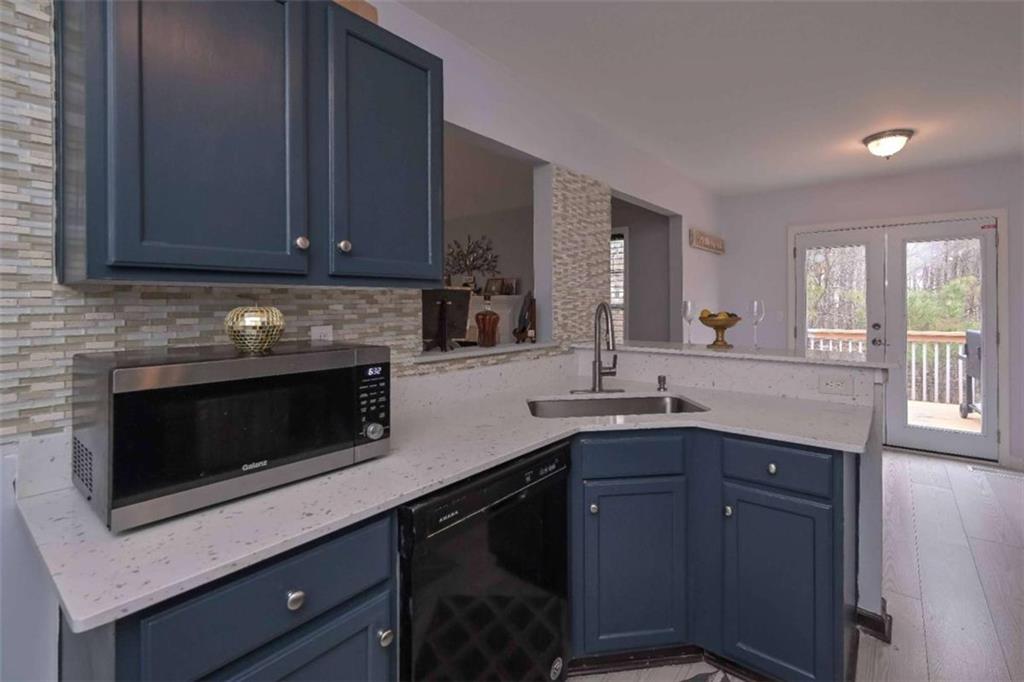 113 Millwheel Drive Villa Rica, GA 30180 - Photo 11 of 34 a kitchen with granite countertop stainless steel appliances a stove sink and cabinets