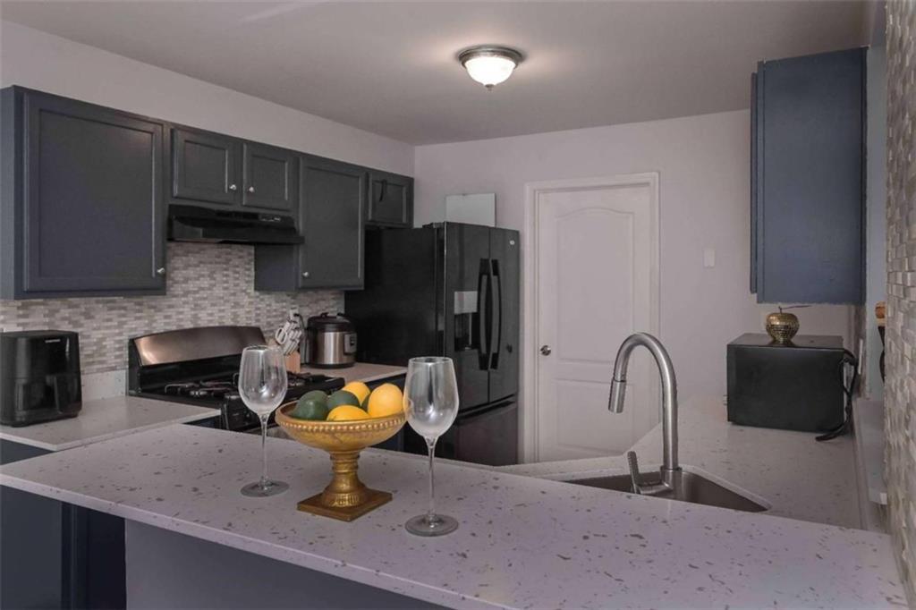 113 Millwheel Drive Villa Rica, GA 30180 - Photo 13 of 34 a kitchen with a sink a stove and refrigerator