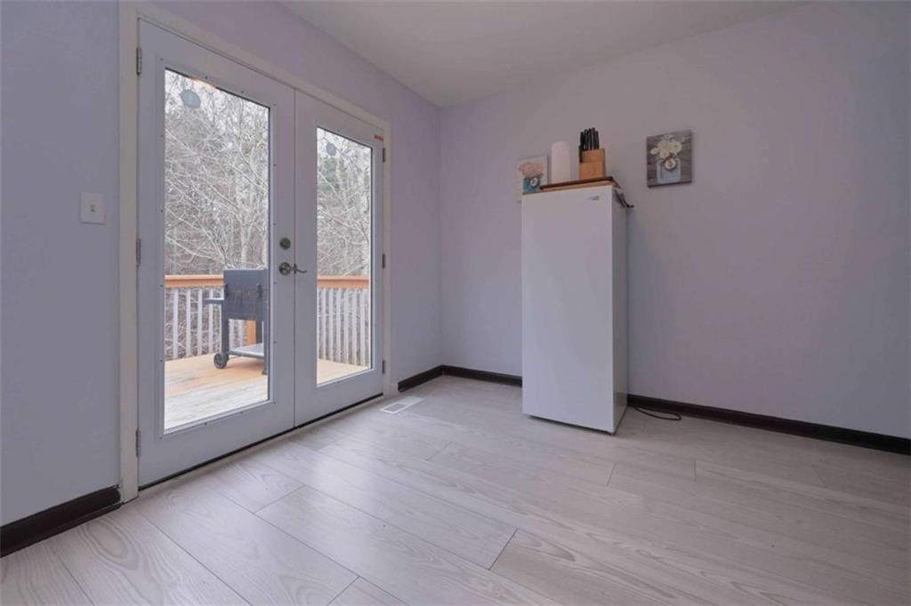 113 Millwheel Drive Villa Rica, GA 30180 - Photo 14 of 34 an empty room with wooden floor and a window