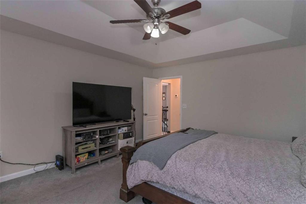 113 Millwheel Drive Villa Rica, GA 30180 - Photo 16 of 34 a bedroom with a bed and a flat screen tv