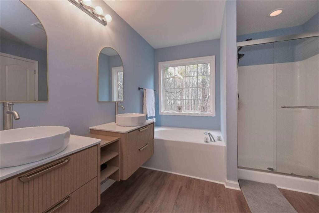 113 Millwheel Drive Villa Rica, GA 30180 - Photo 17 of 34 a bathroom with a tub sink and mirror