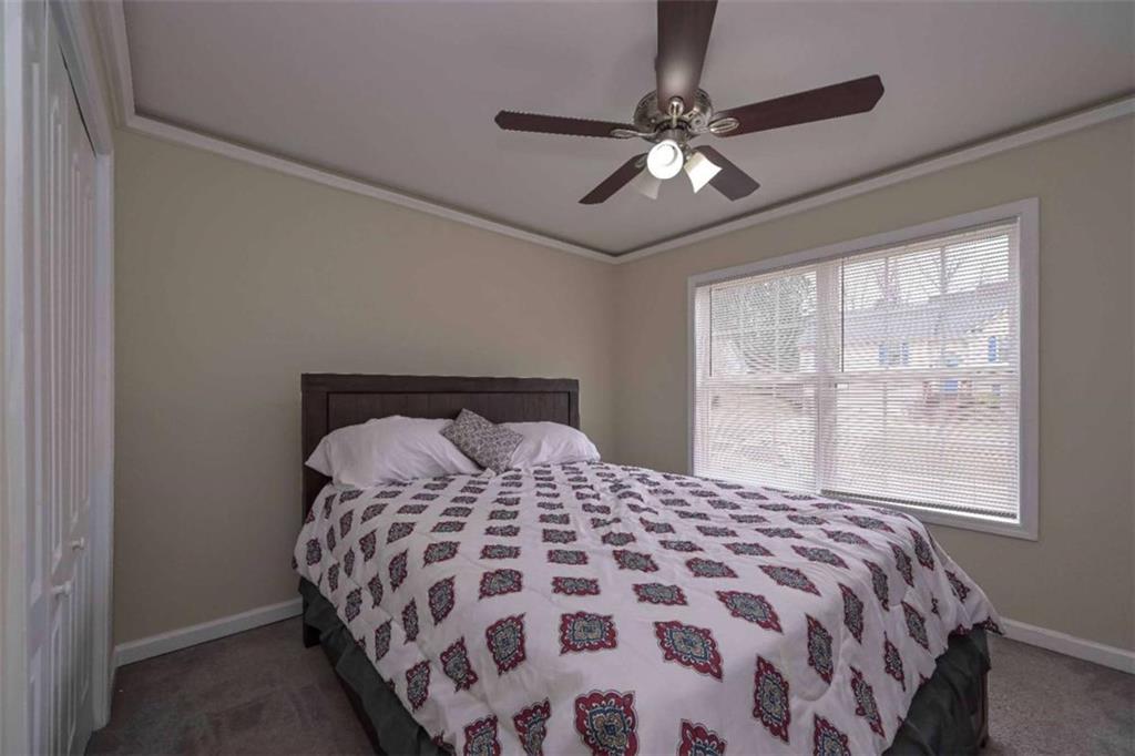 113 Millwheel Drive Villa Rica, GA 30180 - Photo 21 of 34 a bedroom with a large bed and a window