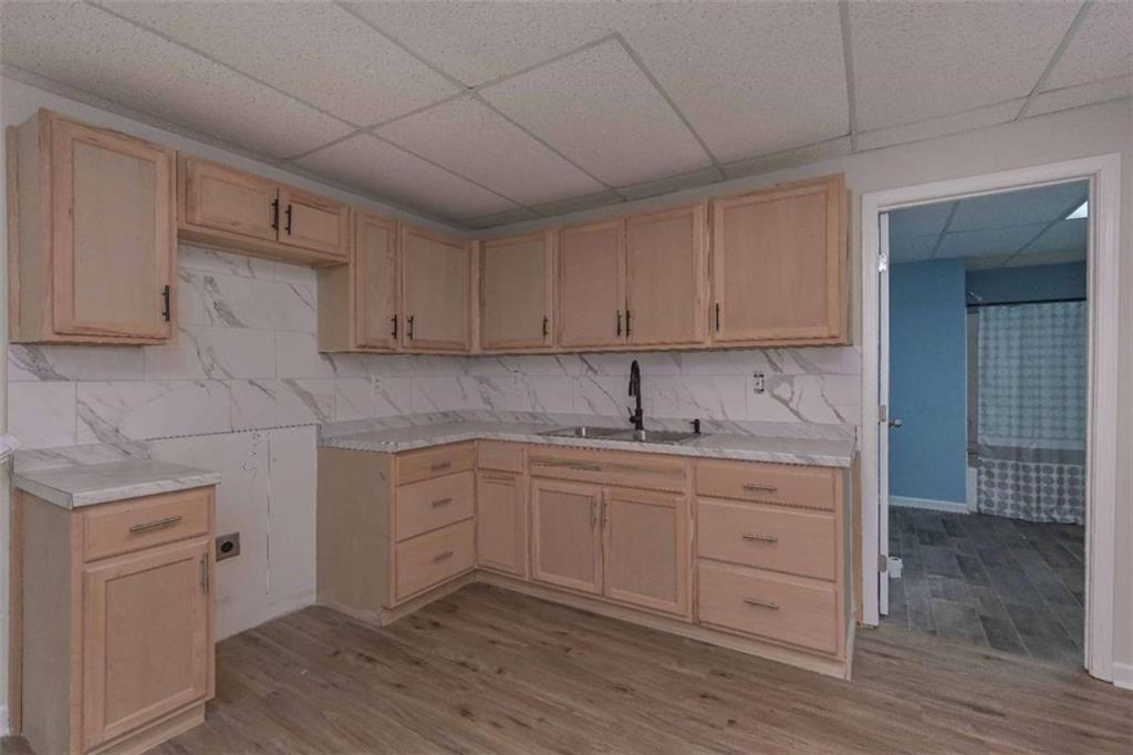 113 Millwheel Drive Villa Rica, GA 30180 - Photo 30 of 34 a kitchen with sink cabinets and wooden floor