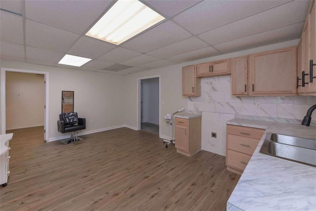 113 Millwheel Drive Villa Rica, GA 30180 - Photo 31 of 34 a kitchen with stainless steel appliances wooden floors and view living room