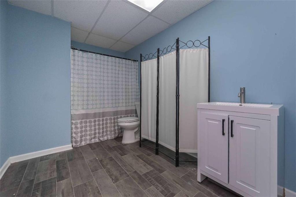 113 Millwheel Drive Villa Rica, GA 30180 - Photo 32 of 34 a bathroom with a sink a toilet and shower