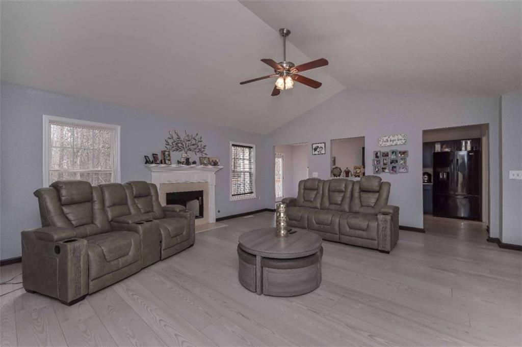 113 Millwheel Drive Villa Rica, GA 30180 - Photo 6 of 34 a living room with furniture a fireplace and a window