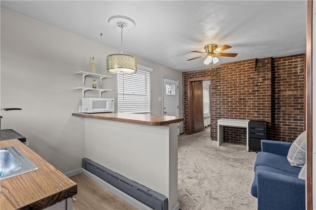 300 Highland Road Pittsburgh, PA 15235 - Photo 12 of 32 a living room with furniture and a fireplace