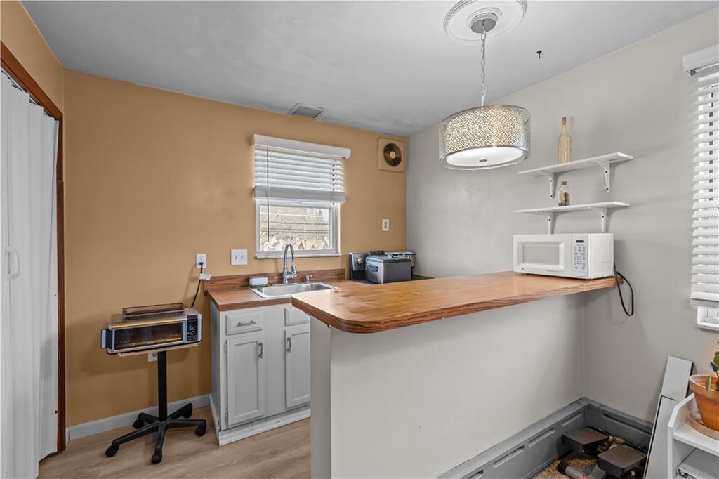 300 Highland Road Pittsburgh, PA 15235 - Photo 13 of 32 a kitchen with a sink a stove a window and cabinets