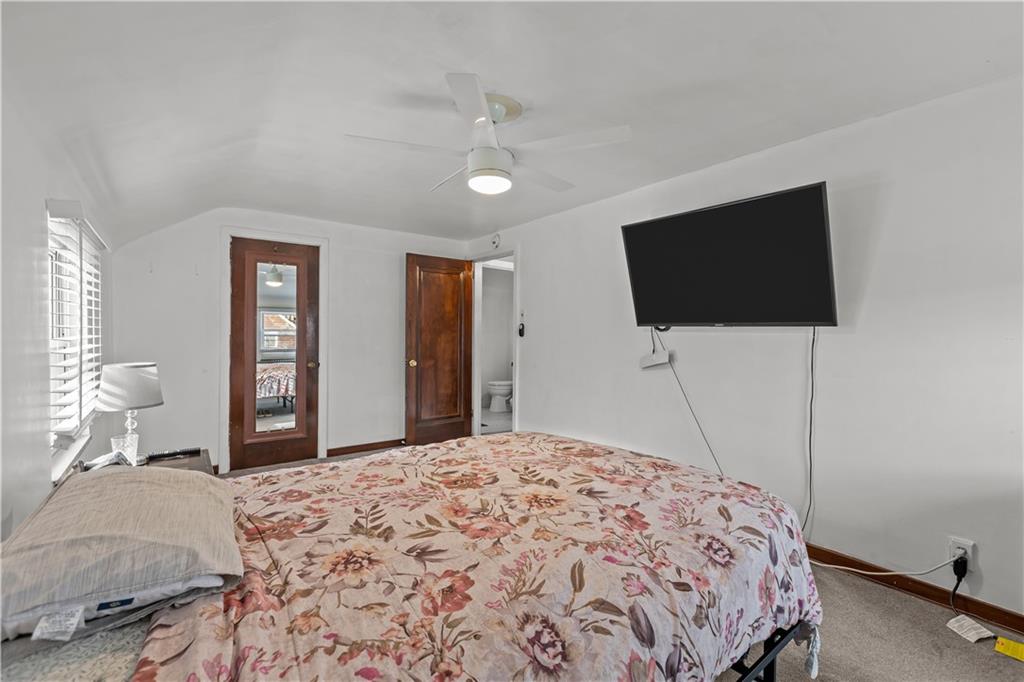 300 Highland Road Pittsburgh, PA 15235 - Photo 20 of 32 a bedroom with a bed and a flat screen tv