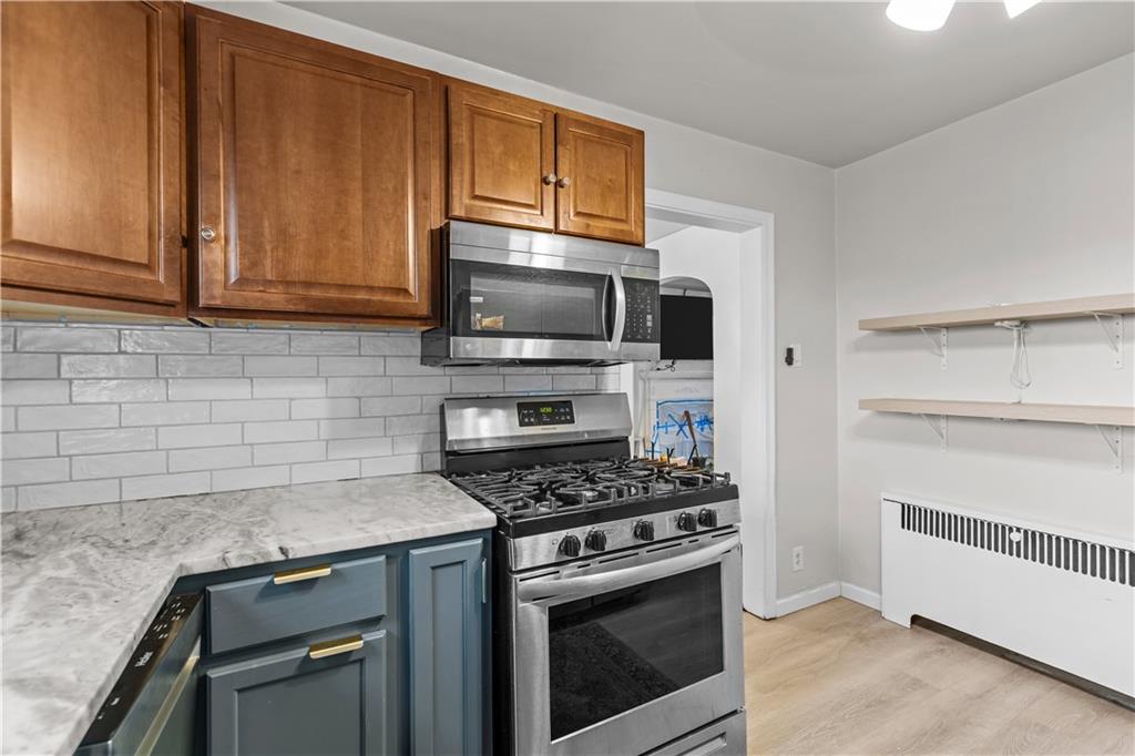 300 Highland Road Pittsburgh, PA 15235 - Photo 9 of 32 a kitchen with cabinets stainless steel appliances and a counter space