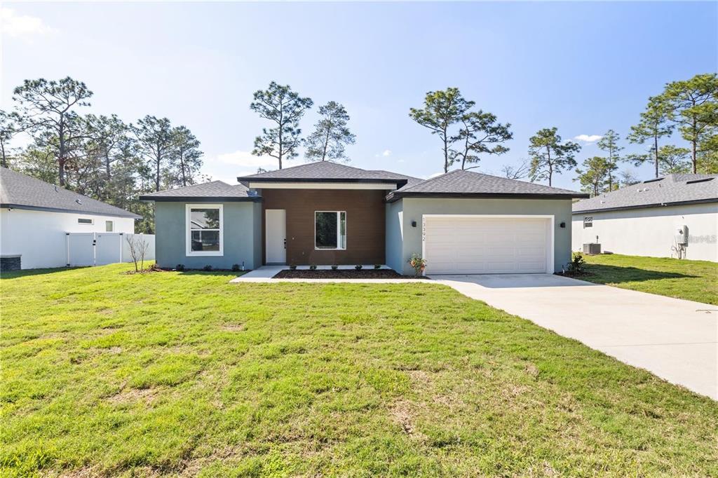 13392 Southwest 63rd Terrace Ocala, FL 34473 - Photo 1 of 1 a view of a house with a yard and a garage