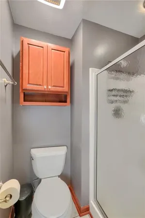 a white toilet sitting next to a bathroom sink