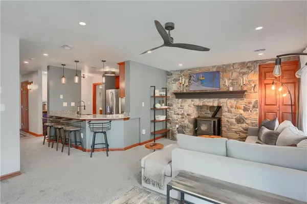 a living room with furniture and kitchen view