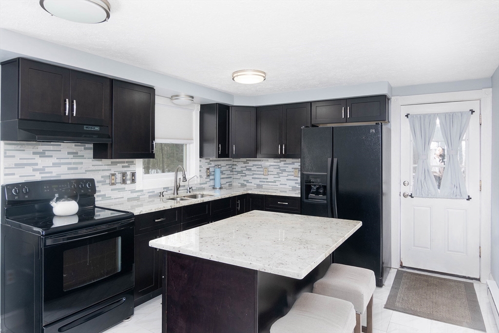 336 Pommogussett Road Rutland, MA 01543 - Photo 7 of 31 a kitchen with stainless steel appliances a sink and a refrigerator